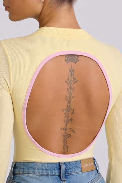 Body Manga Larga Color Amarillo y Sesgo Rosado